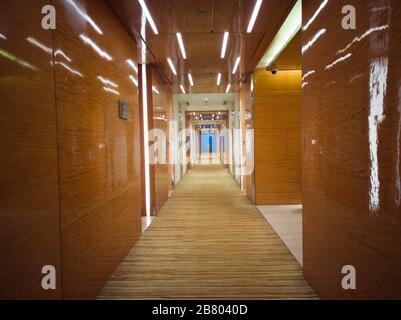 Long beautiful wooden corridor with carpeted floor Stock Photo