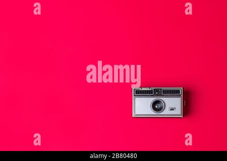 Old vintage Photo Camera on a red Background Stock Photo