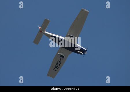 G-EGBJ, a privately-owned Piper PA-28-161 Warrior II, caught in flight over Greenock on the Firth of Clyde. Stock Photo