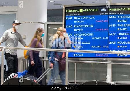 Toronto, Canada. 18th Mar, 2020. Travellers arrive at Terminal 3 passenger pickup area of Pearson International Airport in Toronto, Canada, March 18, 2020. Canadian Prime Minister Justin Trudeau announced that the Canada-U.S. border will close to all non-essential travel, but shipments, trade and commerce will not be affected by the new restriction at the Canada-U.S. border. Credit: Zou Zheng/Xinhua/Alamy Live News Stock Photo