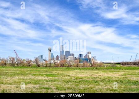 Skyline of Downtown Dallas and Expansive Green Meadow in Foreground - Dallas, Texas, USA Stock Photo
