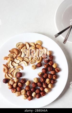 Nuts. Raw Cashew Nuts and Hazelnuts Isolated on White with Copy Space. Stock Photo