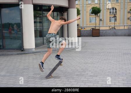 Kiev, Ukraine - July 13, 2018: Teenagers practicing skateboarding on a city street Stock Photo