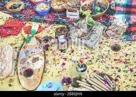 Mess on the floor after barbecue picnic party outdoor - Main focus on lantern and bag - Youth lifestyle, fun, disorder and celebration concept Stock Photo