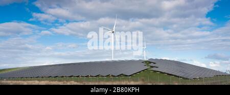 wind turbines and solar panels form alternative enery plant close ...