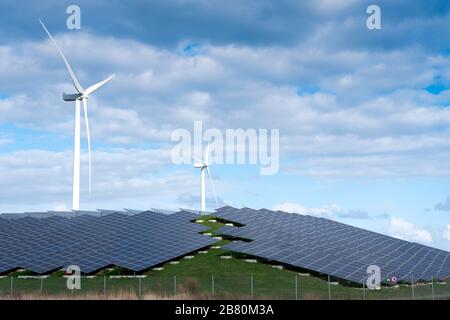wind turbines and solar panels form alternative enery plant close ...