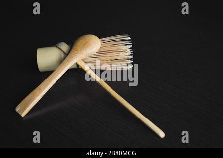 Closeup shot of a cooking brush with wooden spoons on a black background Stock Photo