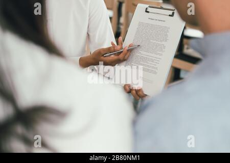 couple consulting lawyer about contract. insurance broker financial advisor giving legal advice to customer. law & investment concept Stock Photo