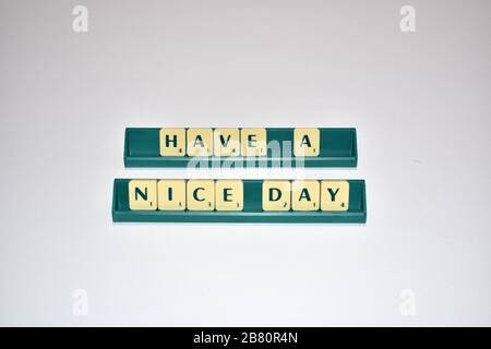 Scrabble tiles spell out Have a Nice day. Motivational quote Scrabble Blocks Letters Grey Background Life quote Induce Alphabet. Stock Photo