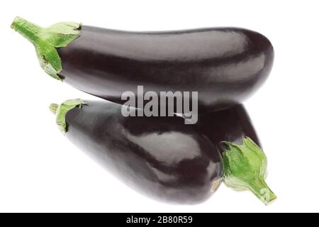 Three ripe eggplants in a heap. On a white background. Stock Photo