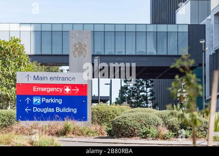 A large sign pointing to emergency and main entrances at Royal North Shore Hospital (RNSH) in St Leonards, Sydney, New South Wales, Australia Stock Photo
