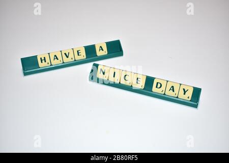 Scrabble tiles spell out Have a Nice day. Motivational quote Scrabble Blocks Letters Grey Background Life quote Induce Alphabet. Stock Photo