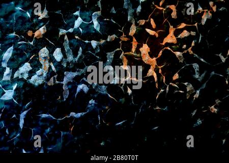 Surface texture with blue, orange and black colors with a strongly cracked surface structure. For abstract backgrounds. Germany Stock Photo