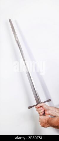 Medieval iron sword held in two hands Stock Photo