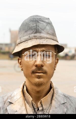 Essaouira, Morocco - February 20 2019 Portrait of street entertaining man covered in golden spray paint, Essaouira, Morocco Stock Photo