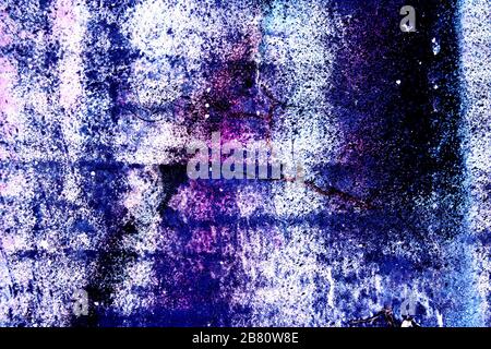 Surface texture with rest of blue and purple paint on concrete surface structure with cracks. For abstract backgrounds. Germany Stock Photo