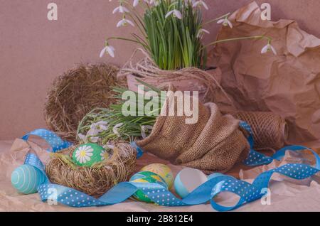 Easter background with snowdrops, eggs and ribbon Stock Photo