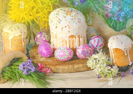 Pastel Easter egg. Pastel colored decorated easter eggs and Easter cake. Pastel colored Easter holiday background. Stock Photo