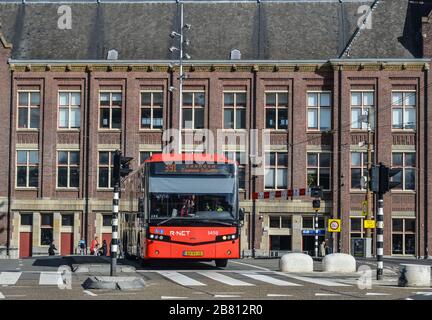 Amsterdam, Holland - Oct 7, 2018. Bus running on street in downtown. Amsterdam known for its artistic heritage and narrow houses with gabled facades. Stock Photo