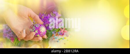 Easter eggs holidays decoration banner. Easter background with Easter eggs, Easter cake and flowers. Girl with Easter eggs. Happy Easter greeting card Stock Photo