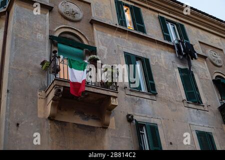 In Rome, Italian flags displayed on the balconies during the Coronavirus epidemic that has hit Italy heavily, Stock Photo