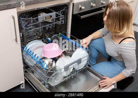A dishwasher is a device that saves time, water and electricity and all dishes are thoroughly washed. Stock Photo