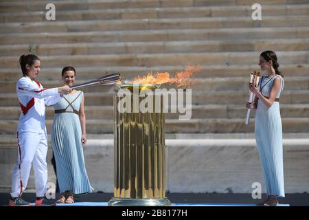 Athens, Greece. 19th Mar, 2020. Greek athlet Katerina Stefanidi(L) is seen lighting the cauldron at the Panathenaic stadium, in Athens, Greece, on March 19, 2020. Credit: Aris Messinis-pool photo/Xinhua/Alamy Live News Stock Photo