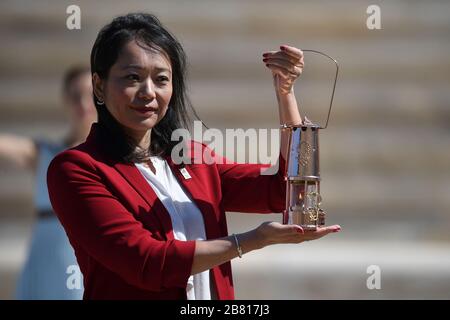Athens, Greece. 19th Mar, 2020. Former Japanese swimmer Imoto Naoko holds a lantern contains the Tokyo Olympic Flame at the Panathenaic stadium, in Athens, Greece, on March 19, 2020. Credit: Aris Messinis-pool photo/Xinhua/Alamy Live News Stock Photo