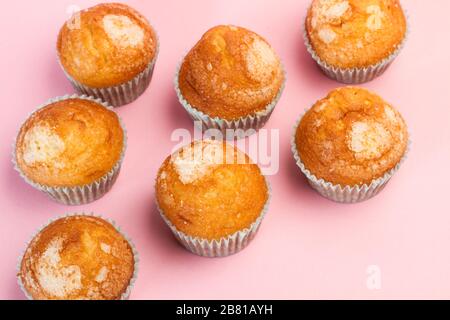 Vanilla and sugar cupcakes on a pink background Stock Photo