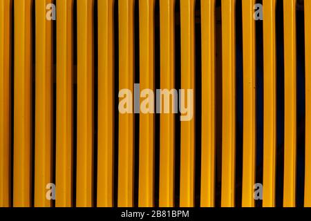Yellow vertical stripes. Black vertical stripes. Warm shot. Texture. Stock Photo
