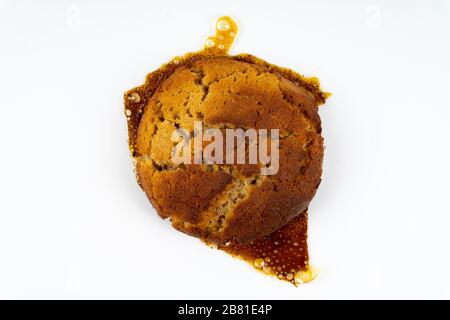 A cookie cake with peanut butter and caramel on white background with copy space - top view Stock Photo