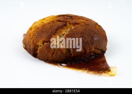 A cookie cake with peanut butter and caramel on white background with copy space - angled view Stock Photo