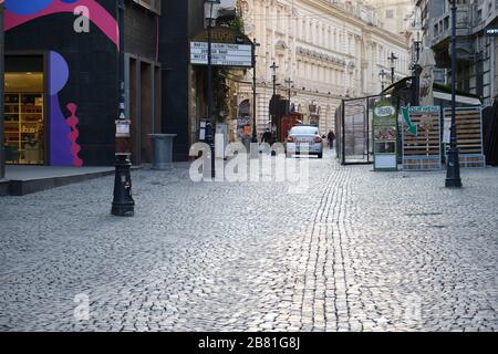 Bucharest, Romania - March 19, 2020: Police car patrolling in an empty old city center after bars and restaurants closed down in order to mitigate the Stock Photo