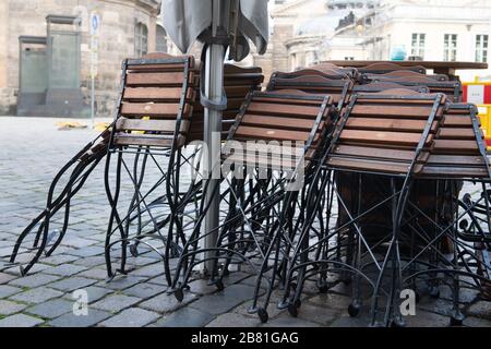 Dresden, Germany. 19th Mar, 2020. Folding chairs are located on Neumarkt in front of a closed restaurant. The corona virus is increasingly bringing public life in Saxony to a standstill. Credit: Sebastian Kahnert/dpa-Zentralbild/dpa/Alamy Live News Stock Photo