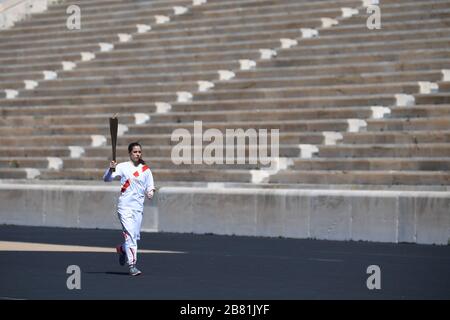 Athens, Greece. 19th Mar, 2020. Greek Olympic medalist in pole vault Katerina Stefanidi holds the Tokyo Olympic Flame at the Panathenaic stadium, in Athens, Greece, on March 19, 2020. Credit: Aris Messinis-pool photo/Xinhua/Alamy Live News Stock Photo