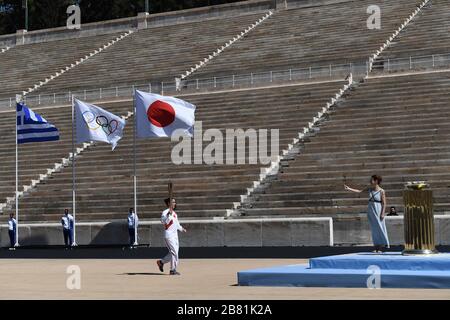 Athens, Greece. 19th Mar, 2020. Greek Olympic medalist in pole vault Katerina Stefanidi holds the Tokyo Olympic Flame at the Panathenaic stadium, in Athens, Greece, on March 19, 2020. Credit: Aris Messinis-pool photo/Xinhua/Alamy Live News Stock Photo