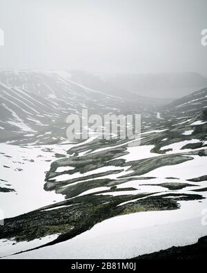 Shot of very textured mountain with snow in west Fjords, Iceland Stock Photo