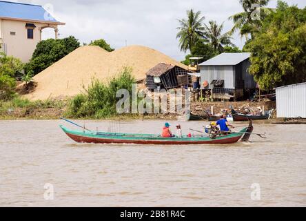 Typical scene with fishing boat in village along Mekong River. Mekong  Delta, Cambodia, southeast Asia Stock Photo