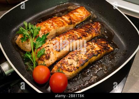 Fresh salmon fillets grilled in a pan Stock Photo