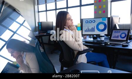 Caucasian woman working on computer and thoughtful Stock Photo