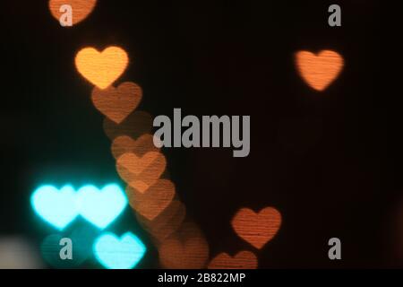 Valentines Colorful heart-shaped on black background lighting bokeh for decoration at night backdrop wallpaper blurred valentine, Love Pictures backgr Stock Photo