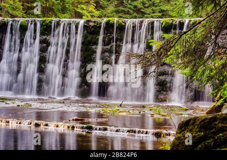 large waterfall on a mountain river in the forest Stock Photo
