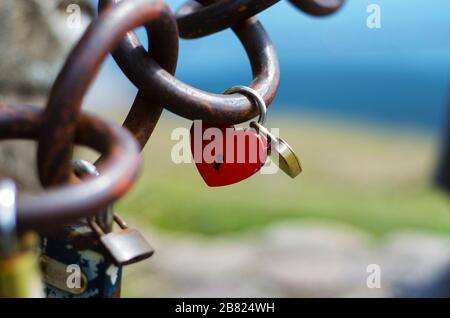 lockers of lovers in the shape of heart buttoned on chains Stock Photo