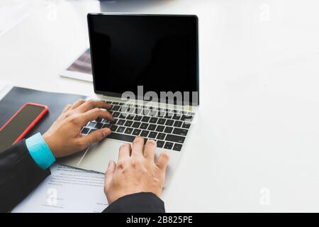Businessman using laptop while conference. Businessmen discussing together in meeting room. Business team meeting and discussing project plan. Stock Photo