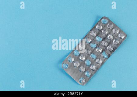 Used blister pack from tablets medicine on blue background. Medical blister pack opened and empty without pills top view. Medical and healthcare conce Stock Photo