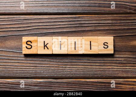 Skills word written on wood block. Skills text on wooden table for your desing, concept. Stock Photo