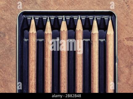 Wooden pencils in a box, separated by an empty space. Concept picture for social distancing. Stock Photo