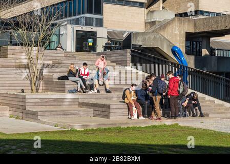 Ixelles, Brussels Capital Region / Belgium - 02 06 2020: Young mixed group of students having a lunch break at the stairs of the sports center of the Stock Photo