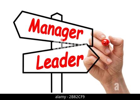 Leader versus Manager. 2-way hand-drawn signpost on whiteboard with the words manager and leader Stock Photo