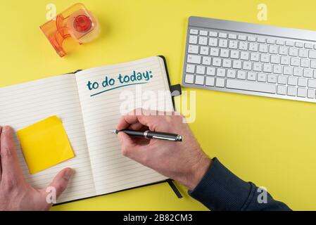 top view of person writing to-do list on notepad, time management and task management concept Stock Photo